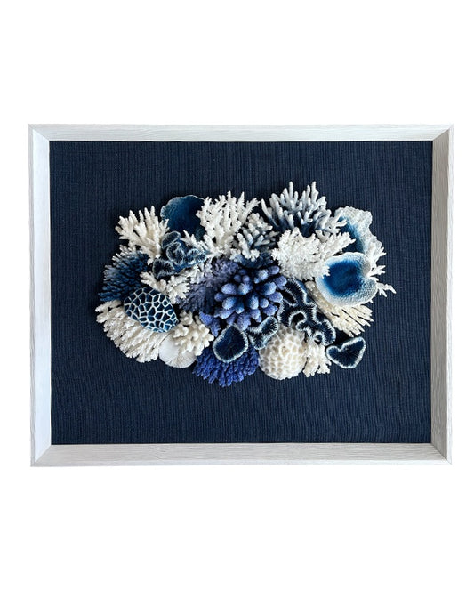 Framed artwork with blue and white coral arrangement on a dark blue background