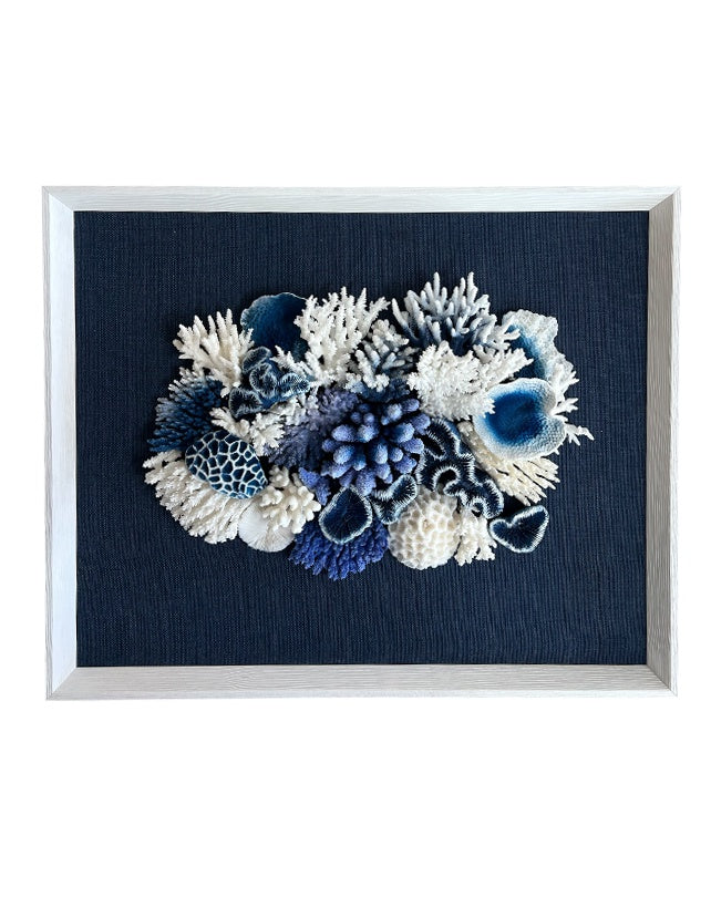 Framed artwork with blue and white coral arrangement on a dark blue background