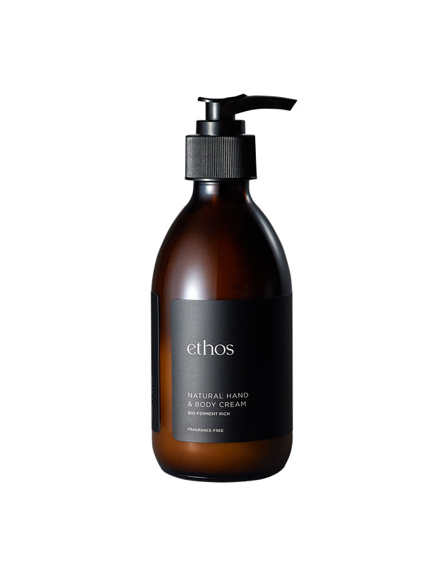 Brown bottle of ethos natural hand & body cream on a white background