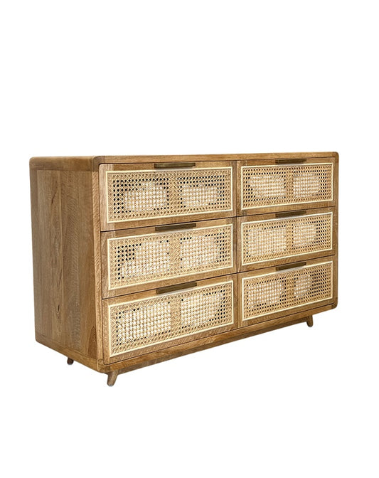 Wooden dresser with wicker drawers on a white background