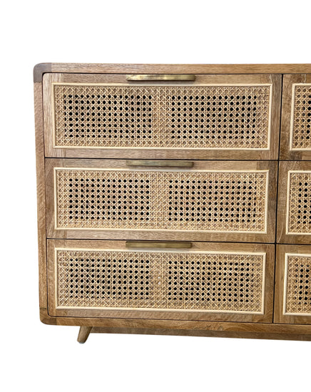 Wooden dresser with wicker drawers on a white background