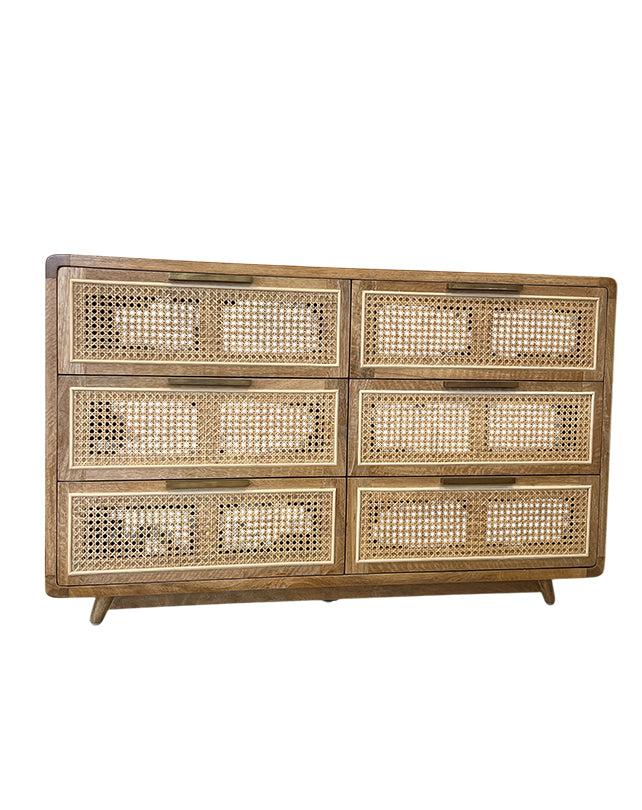 Wooden dresser with wicker panels on a white background
