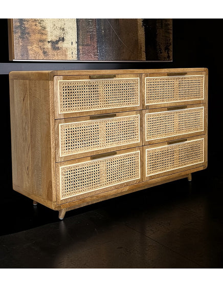 Wooden dresser with woven drawers against a dark background