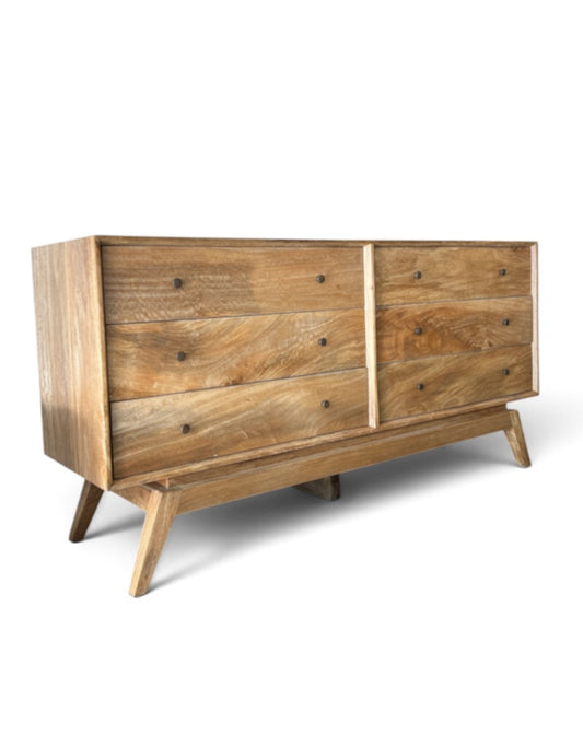 A mid-century modern wooden dresser with a natural oak finish, featuring six drawers, dark metal knobs, and angled legs, shown on a white background.