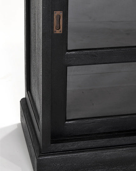 Close-up of a wooden cabinet with a metal handle on a white background