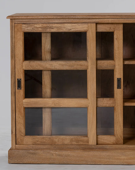 Wooden cabinet with glass panels on a gray background