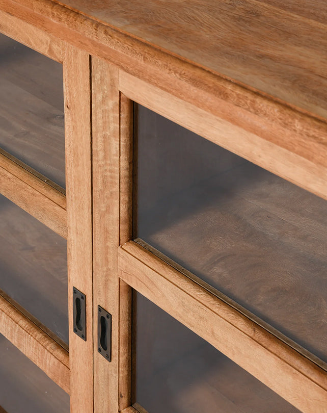 Close-up of a wooden cabinet with glass panels